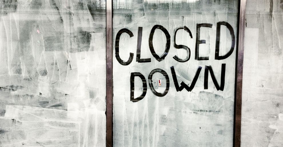 retail shop window closed down sign